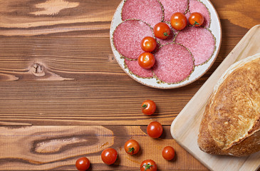 food background of italian delicacy salami on wooden board