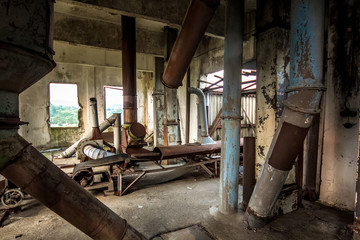 Fototapeta na wymiar Old abandoned silo elevator with rusty equipment left in Eshera, Abkhazia