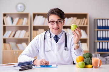 Doctor in dieting concept with fruits and vegetables