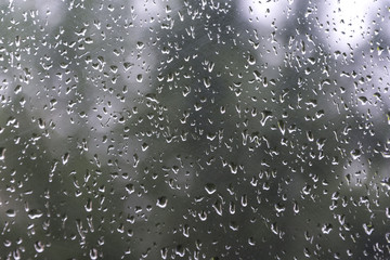 Drops on glass after rain in different sizes