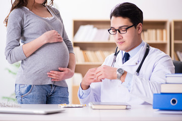 Pregnant woman visiting doctor for consultation