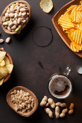 Lager beer and snacks on stone table