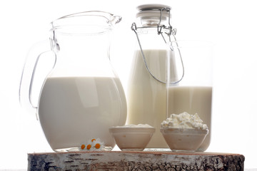 milk products - tasty healthy dairy products on a table sour cream in a glass bowl, cottage cheese and milk jar