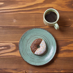 food plate of donut and croissant with mug of coffe on wooden background