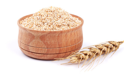 wheat porridge in wooden bowl isolated on white background