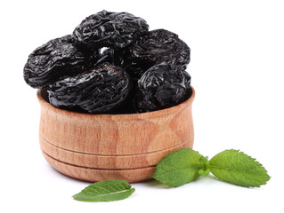 Dried plums - prunes in wooden bowl isolated on white background