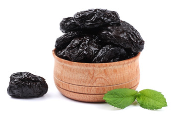 Dried plums - prunes in wooden bowl isolated on white background