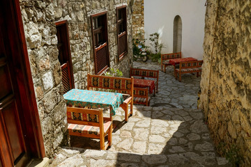 Fototapeta na wymiar Street eastern turkish cafe with pattern tablecloth and wooden chairs