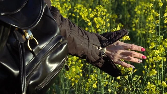 A girl takes a rape-flower hand. Slow motion