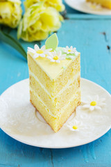 A piece of lemon sponge cake on a plate.