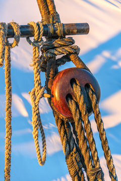 Triple Deadeye Detail of Schooner Rigging / Close-up perspective of wooden triple deadeye in rigging of a working schooner.