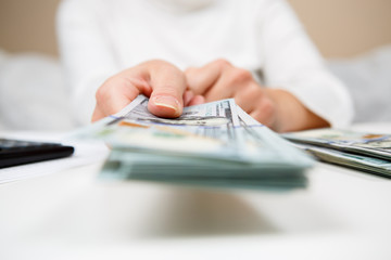 Fototapeta premium Hands of person proposing money to you - closeup shot