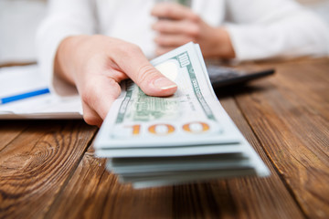 Hands of person proposing money to you - closeup shot