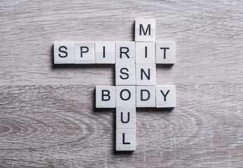 Spirit soul mind and body words made of wooden cubes