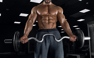 Fototapeta na wymiar Adult guy bodybuilder posing in gym
