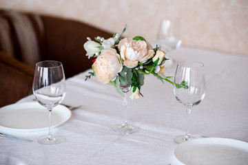 Dining table setting decorated with flowers.