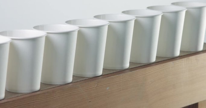 pan camera movement shows white paper cups raw
