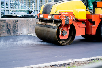 Close view on the road roller working on the new road construction site