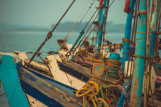Noses of fishing boats standing on the dock in the background Arabian Sea