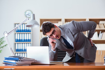 Businessman feeling pain in the office