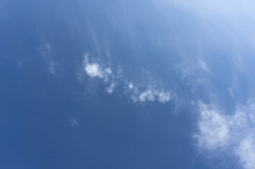 Naklejka na ściany i meble A blue sky with a white cloud. Colorful bright blue sky.