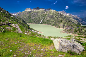 Panoramic mountain road leading to Grimselpass with Grimselsee