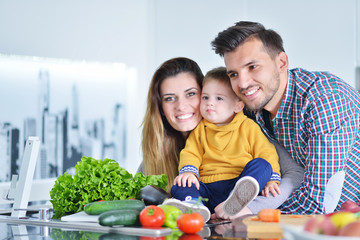 Happy family preparing vegetables together at home in the kitchen
