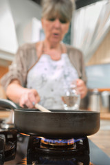 Making food in frying pan.