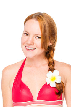 Close-up portrait of a woman with a plumer flower in her hair on a white background