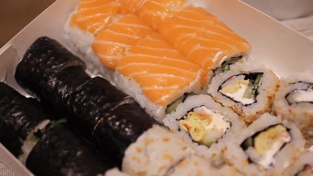 Fresh sushi on black table in motion. HD