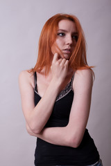 Naklejka premium Gorgeous busty woman in studio photo on gray background. Sexuality and sensuality. Attractive model