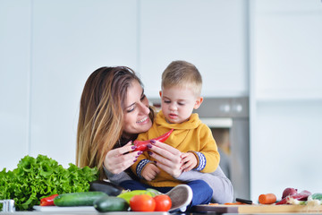 Fototapeta premium Mother and child preparing lunch from fresh veggies