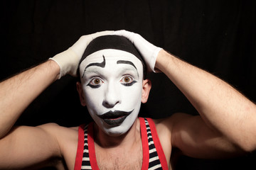 A funny stupid mime grabbed his head