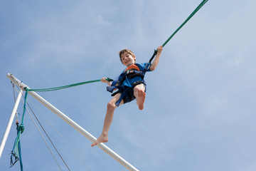 Young boy  enjoying jumping with trampoline jumping rope
