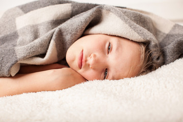 Fototapeta na wymiar Unhealthy child lying in bed