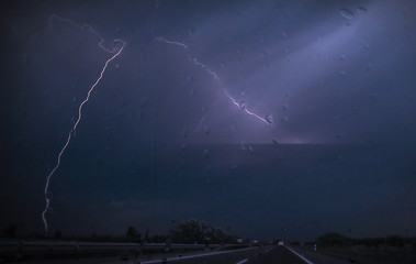 Fototapeta na wymiar on the road to the storm, lightning in the dark sky