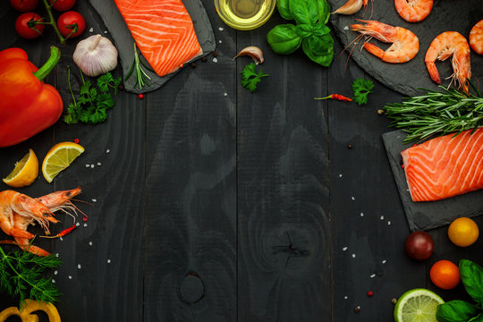 Fresh salmon and shrimp with fresh aromatic spices and vegetables-background