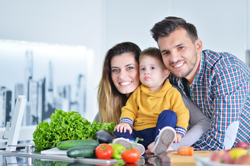 Happy family preparing vegetables together at home in the kitchen