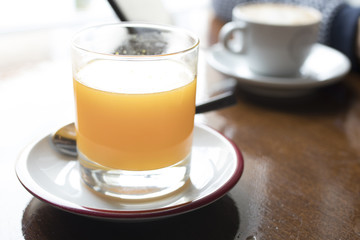 glass of juice and coffee with milk, breakfast