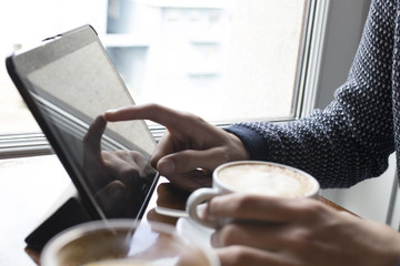 having breakfast with the cellphone in the cafeteria