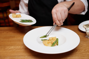 Chef is decorating a dish