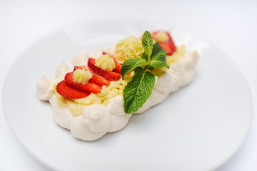Dessert with strawberries and mint on a bise closeup