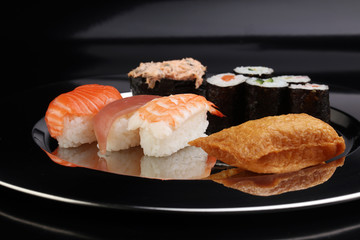 close up of sashimi sushi set with chopsticks and soy - sushi roll with salmon and sushi roll, delicious maki and nigiri