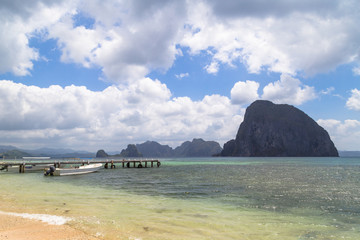 View of the pier with a boat at sea. In the background of the island. Philippines, Palawan, El Nida.