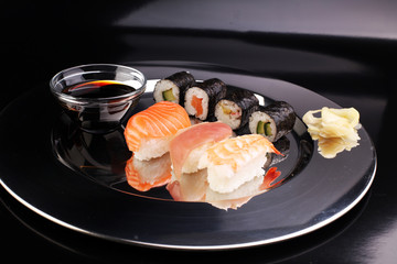 close up of sashimi sushi set with chopsticks and soy - sushi roll with salmon and sushi roll, delicious maki and nigiri
