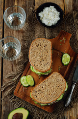 Ricotta sprouts avocado cucumber rye sandwich