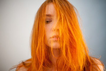 Naklejka premium Dreammy portrait of beautiful redhead woman in soft focus in studio photo. Attractive and beautiful woman