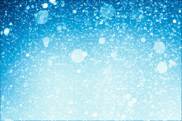 Abstract shimmering bokeh or glitter lights on blue background. Circles and defocused particles. Template for design