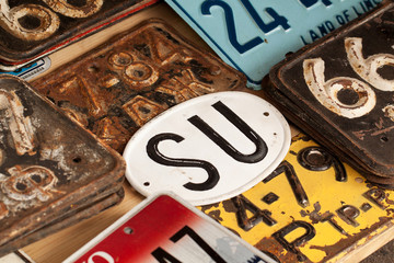 Different car plates and other metal signs and plates