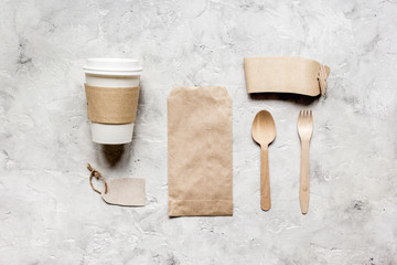 breakfast take away with paper bags on gray table background top view mock up